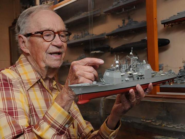 Ed Wiswesser is pictured with a model train.