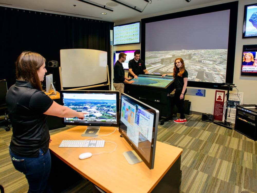 Students work with technology and equipment in the Red Cell Analytics Lab