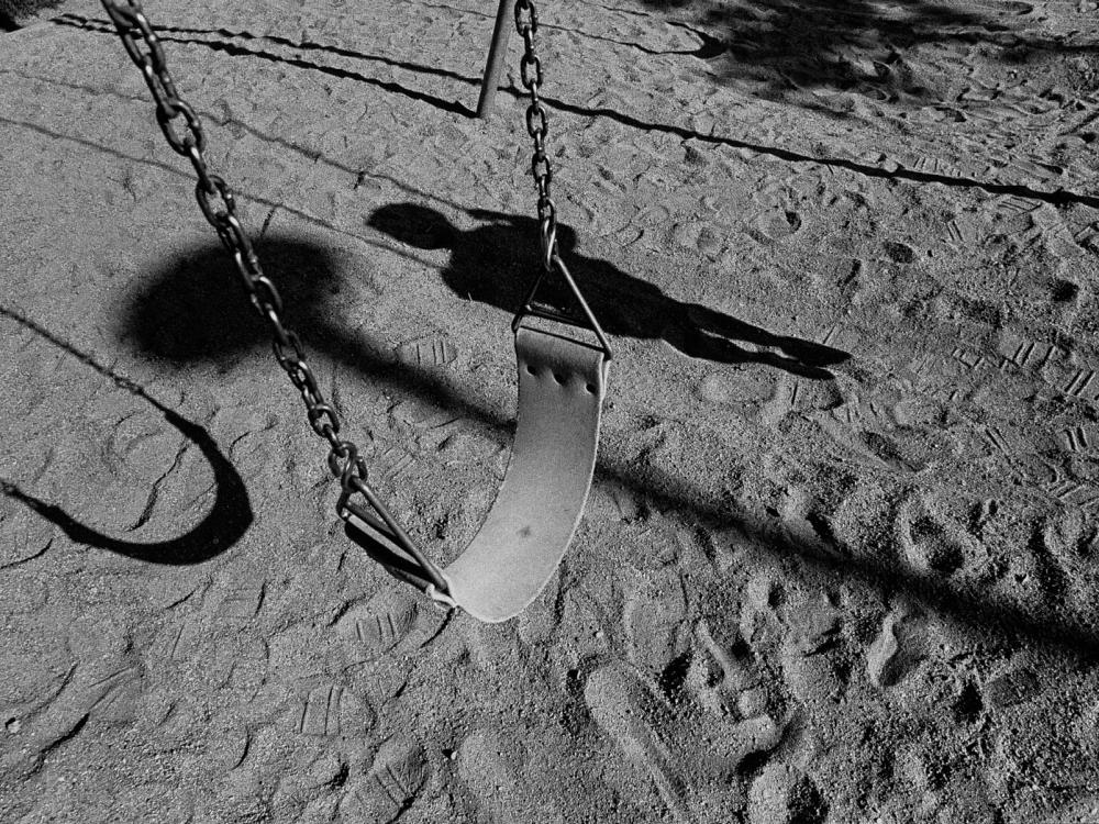 Empty swingset on a playground stock image