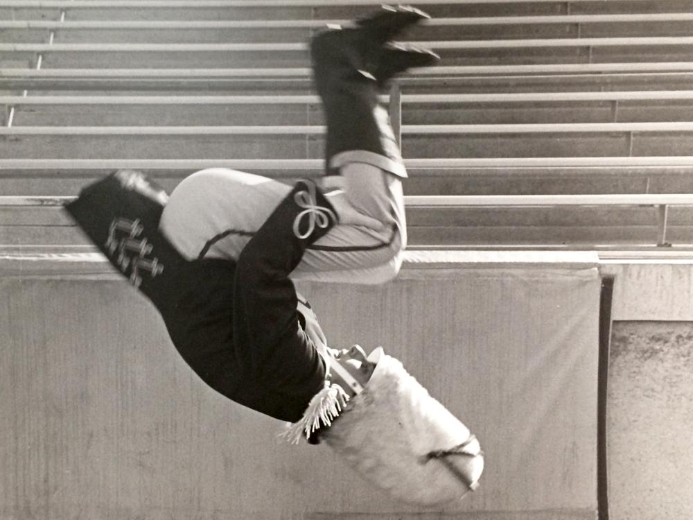 Richard Gorodesky, in Blue Band uniform, mid-air performing a flip