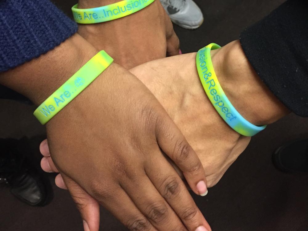 Students hands wearing diversity bracelets