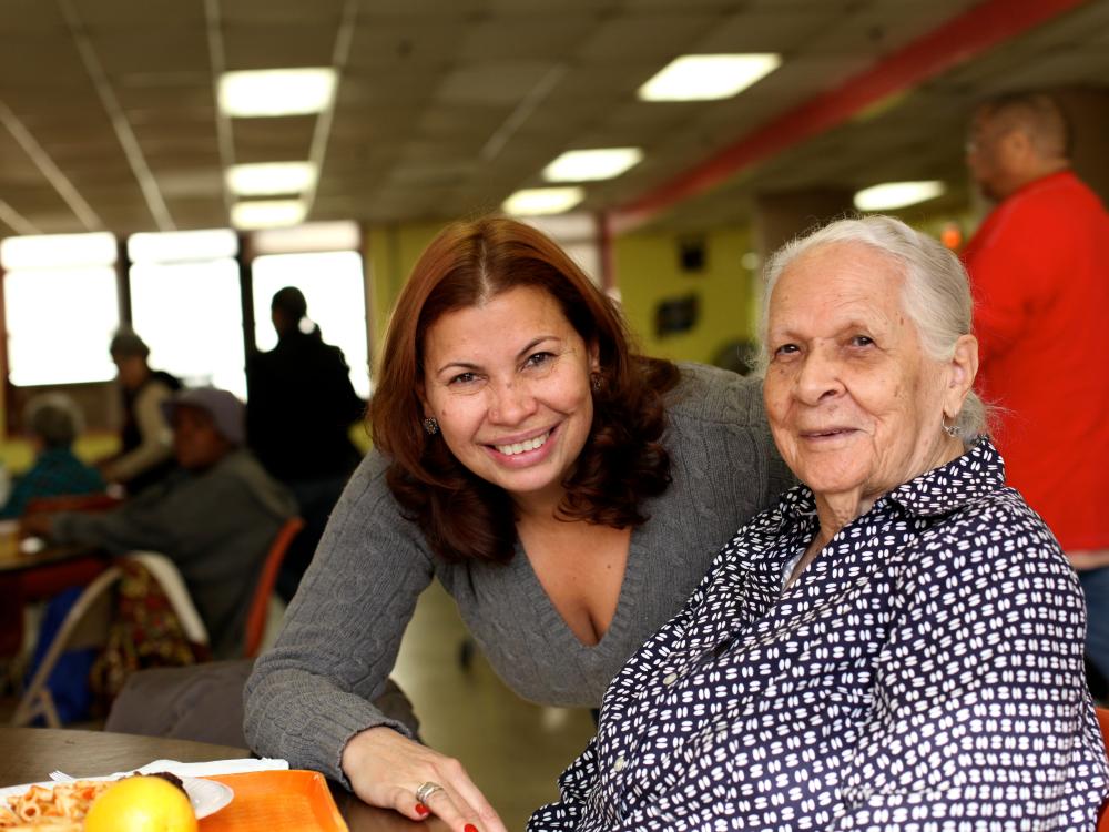 A geriatric caregiver with an older adult patient.