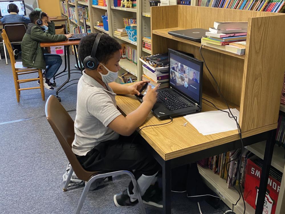 Elementary students work on a science experiment with their pre-service teacher from Penn State via Zoom.