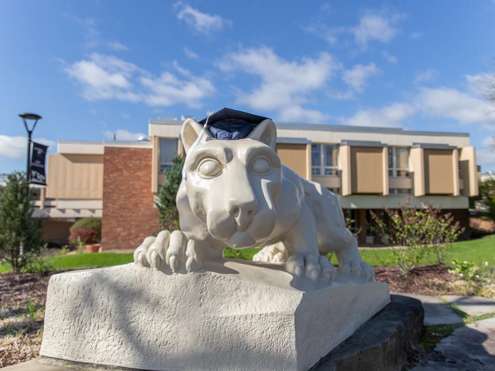 Lion shrine statue with graduation mortarboard