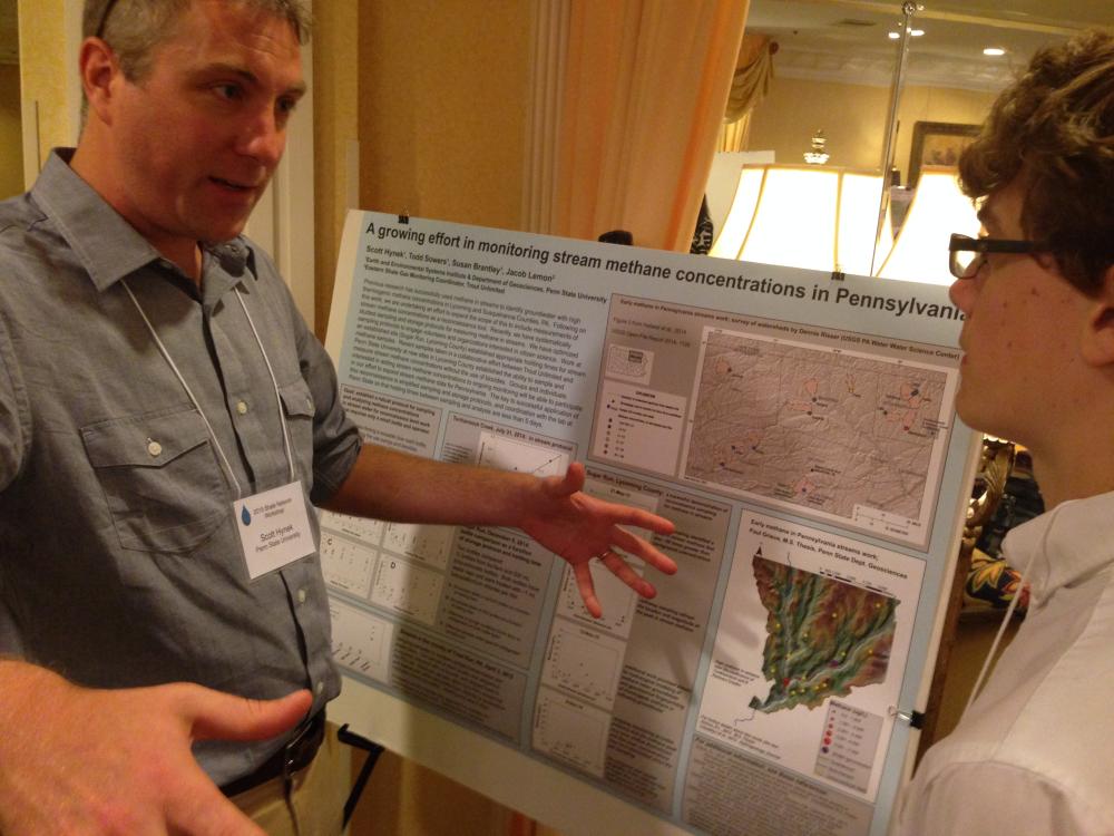 Penn State researcher Scott Hynek talks with a student about his research during the 2015 Shale Network conference 