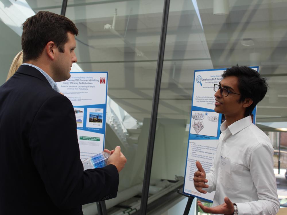 Student talking to professional representative at poster presentation