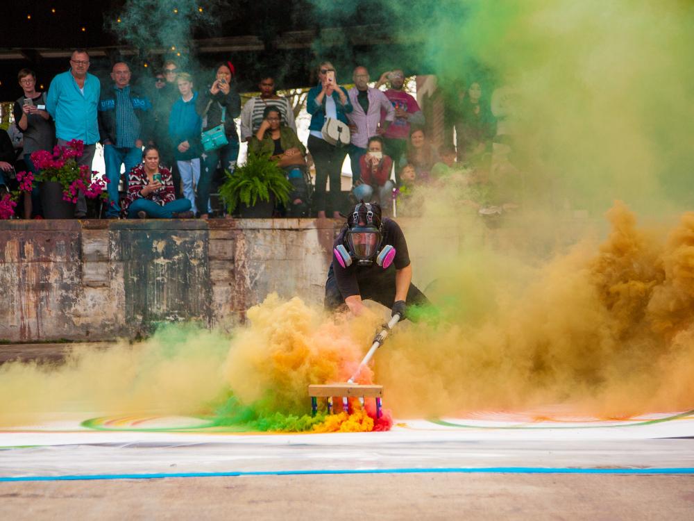 Artist surrounded by colorful smoke