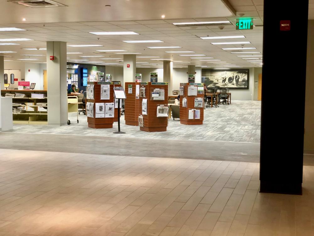 MacKinnon's Lounge, first floor Paterno Library, showing tables, chairs and displays of print newspapers from Pennsylvania and around the world