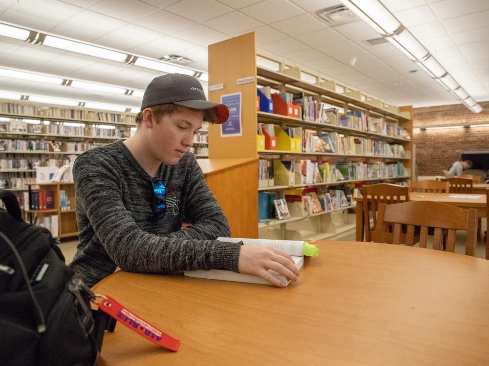 Mackinly Adams sitting in library