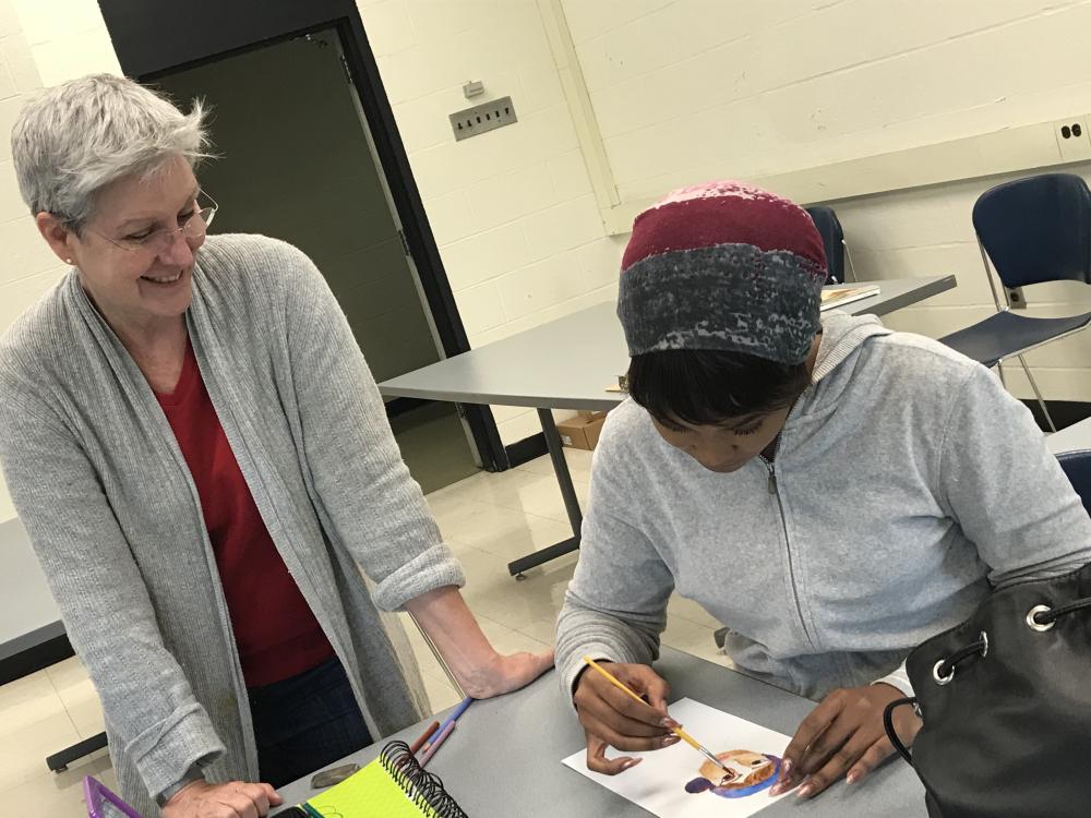 Teacher looking at student work on document