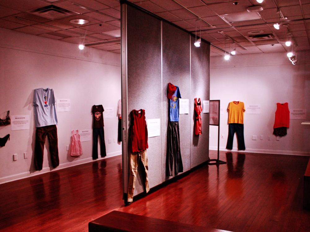 Clothing from "What Were You Wearing?" exhibit hangs on walls of gallery