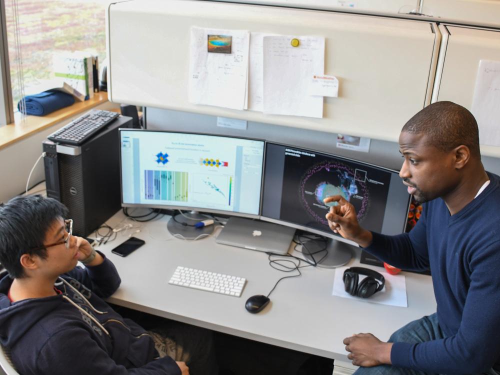 Ismaila Dabo (right) speaks with one of his graduate students