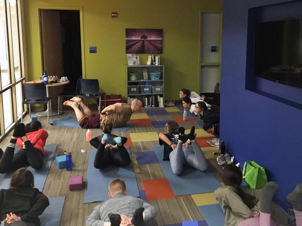 Students take part in yoga exercises as part of a wellness retreat during the spring 2019 semester.