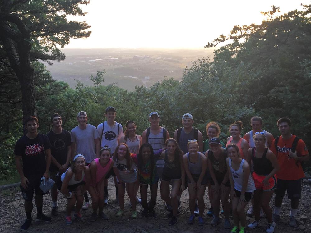 A group of LEAP students stand atop Mount Nittany posing for the camera