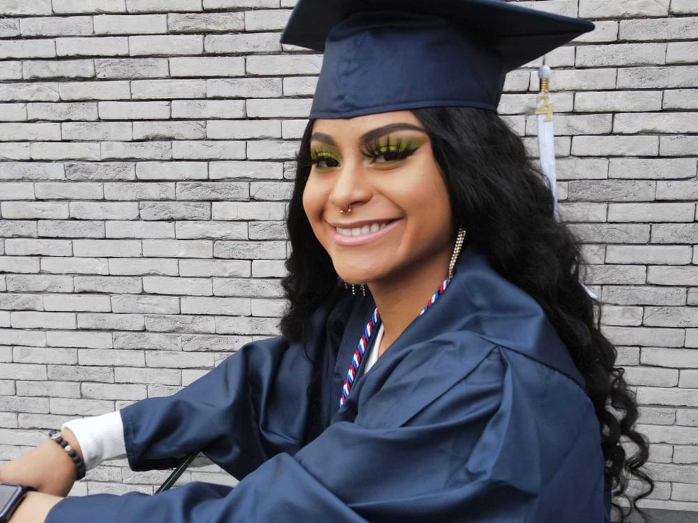 Yanelis Funez smiling in her cap and gown.