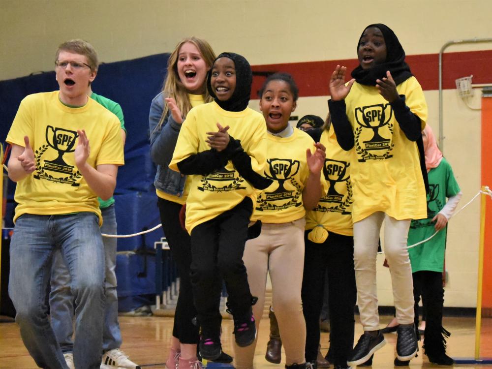 Pictured left to right, Matt Krause, Julie Lauris, Laila Abdirahman, Inihya Vaughn and Samira Babiker cheer on the unicorn ice cream truck during the 13th annual PLASTCar competition, held Dec. 11 at Penn State Behrend.