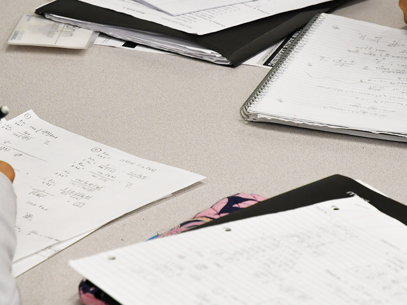 Photograph of students doing homework on a table