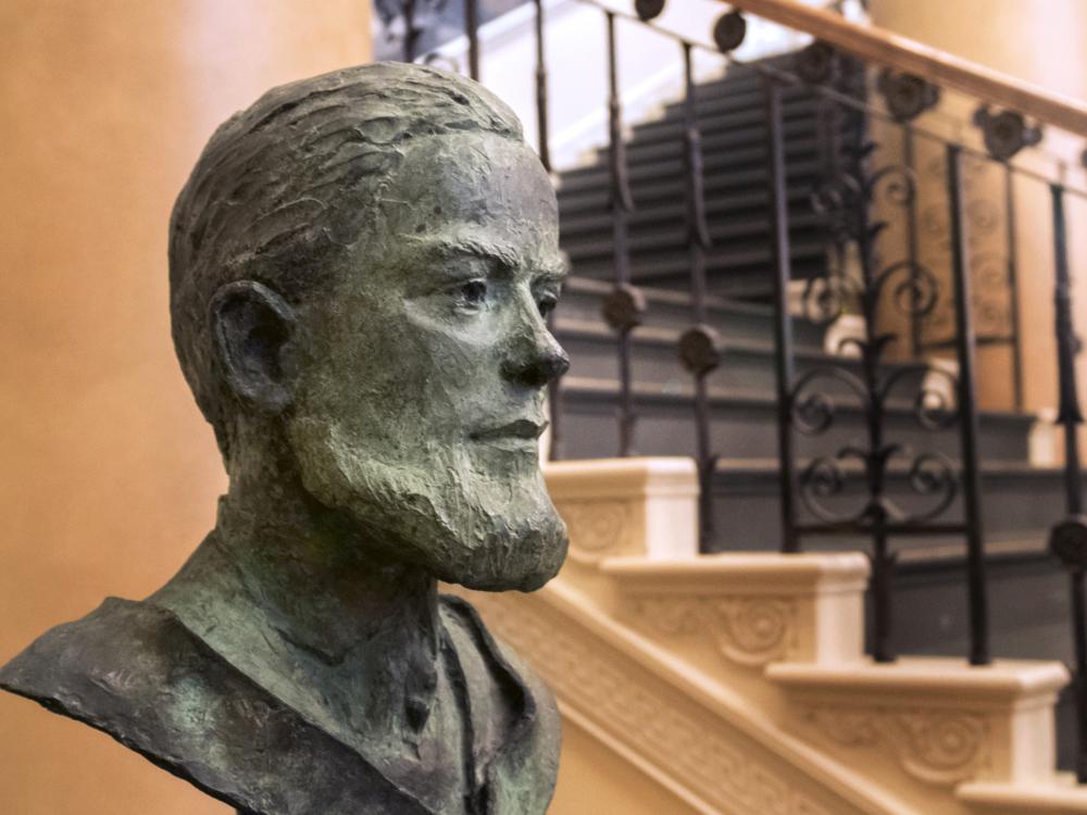 A bust of Evan Pugh near a wide staircase