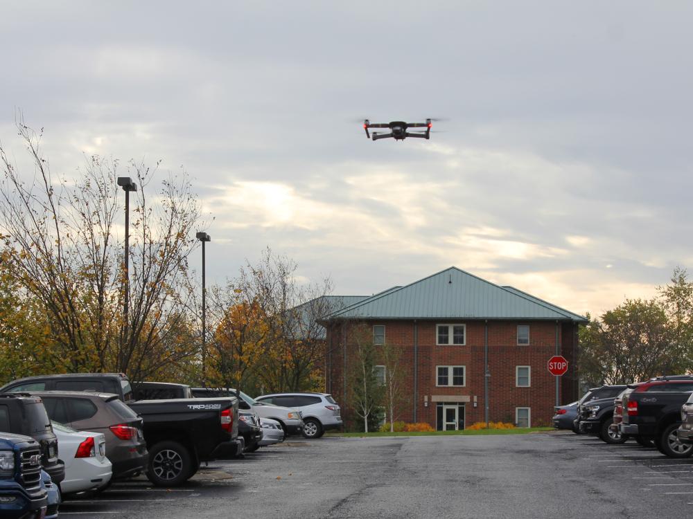 Drone flying above Leonhard Building parking lot