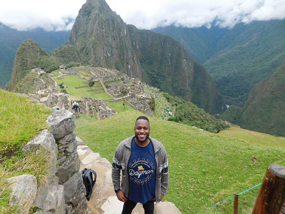 SIA student Erick Jenkins stands on a mountain overlooking the ruins at Machu Picchu.