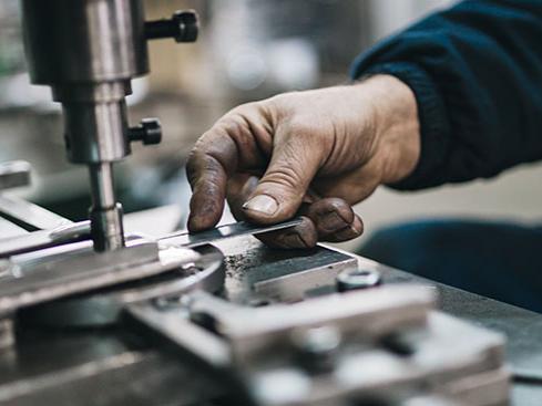 Close-up of someone working with manufacturing equipment