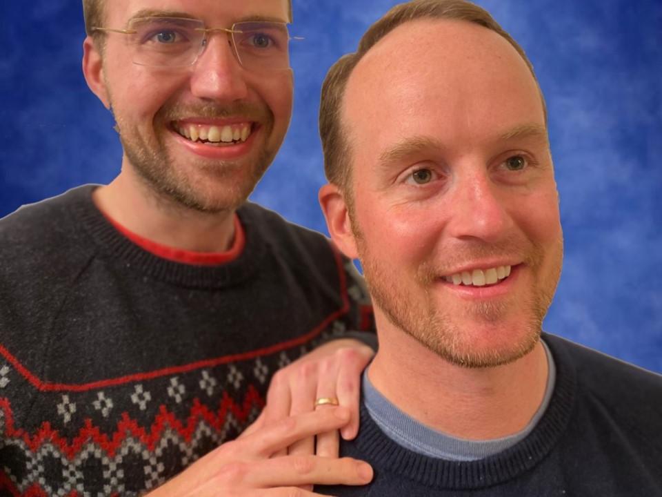 two students in sweaters smile and pose together for a headshot photo