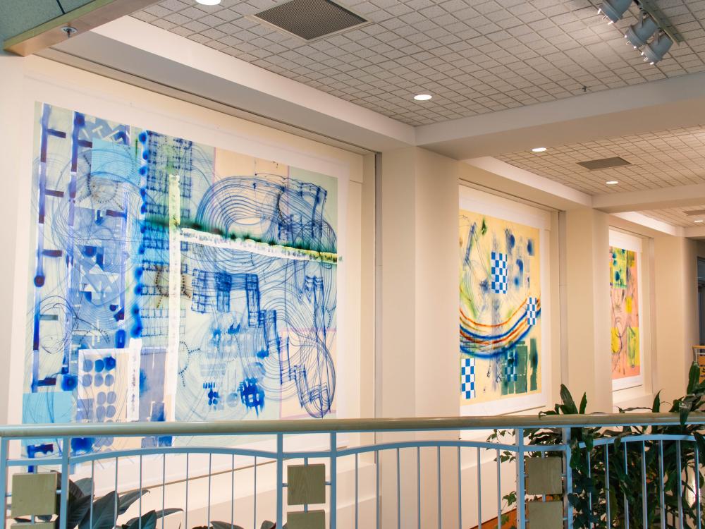 Three large colorful murals
