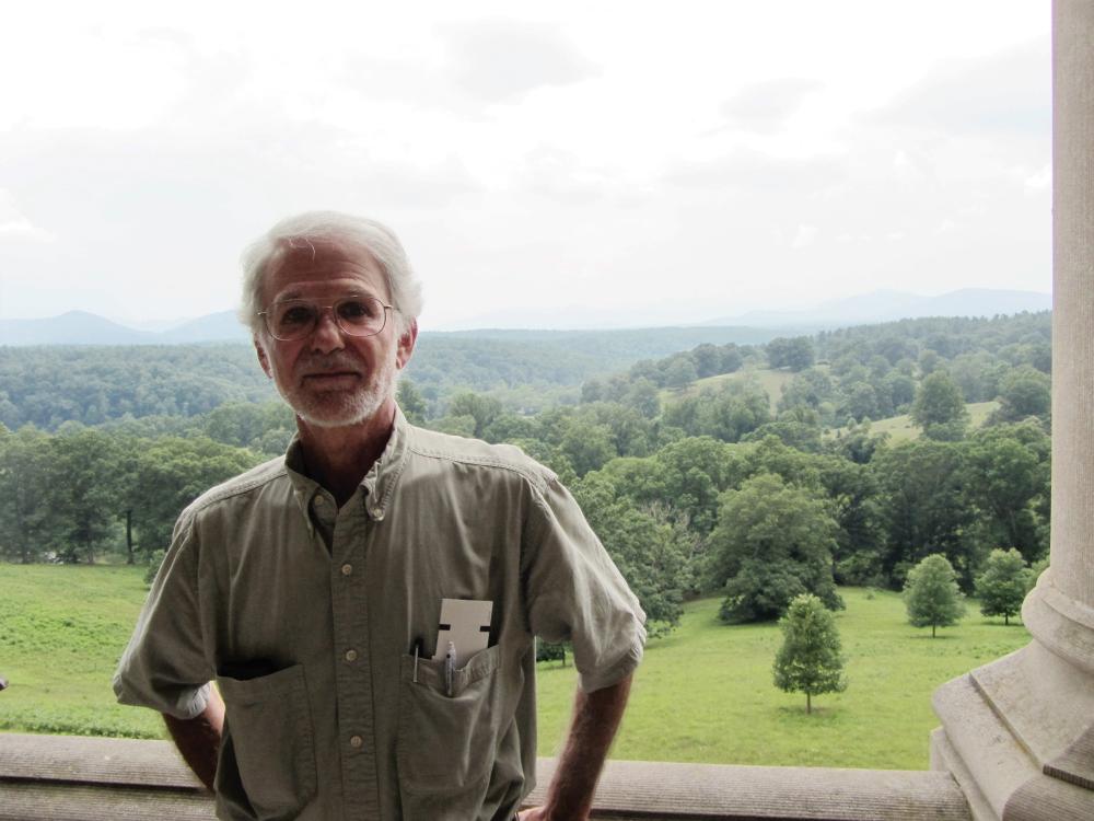 Shelby Fleischer poses in front of a landscape.
