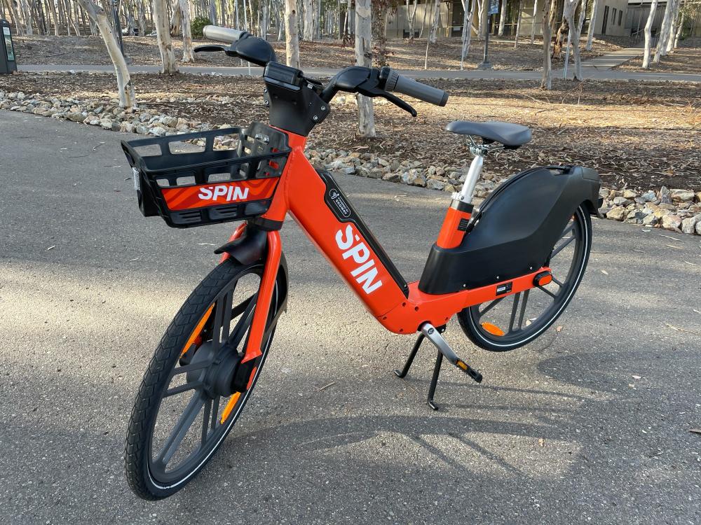 An orange and black Spin e-bike