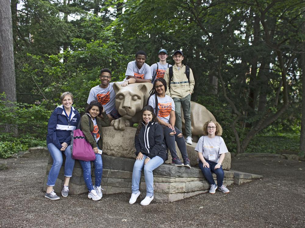 Campers posing around Nittany Lion