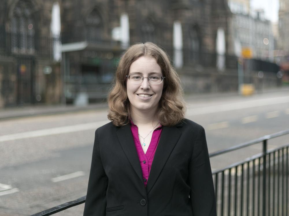 photo of professional female standing on the street