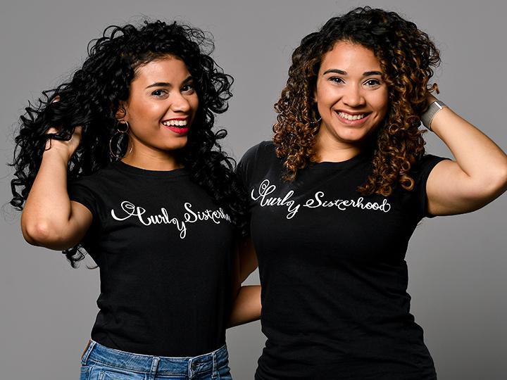 The Varona Sisters pose with their Curly Sisterhood t-shirts.