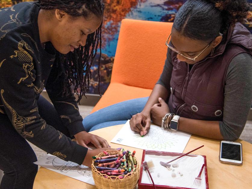 Female students engaging in activities in wellness suite