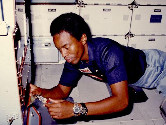Astronaut Guy Bluford works while floating in a space shuttle