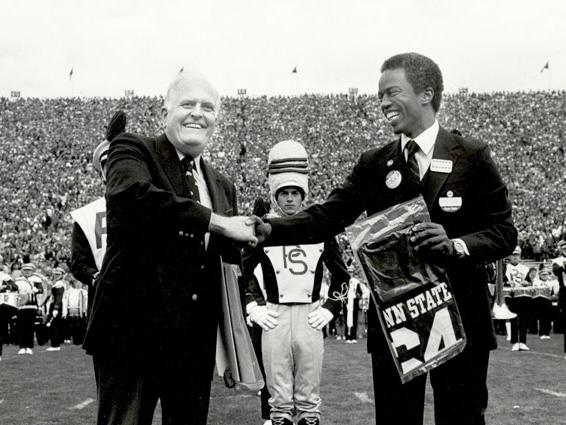 Guy Bluford presents Bryce Jordan with football jersey, 1983