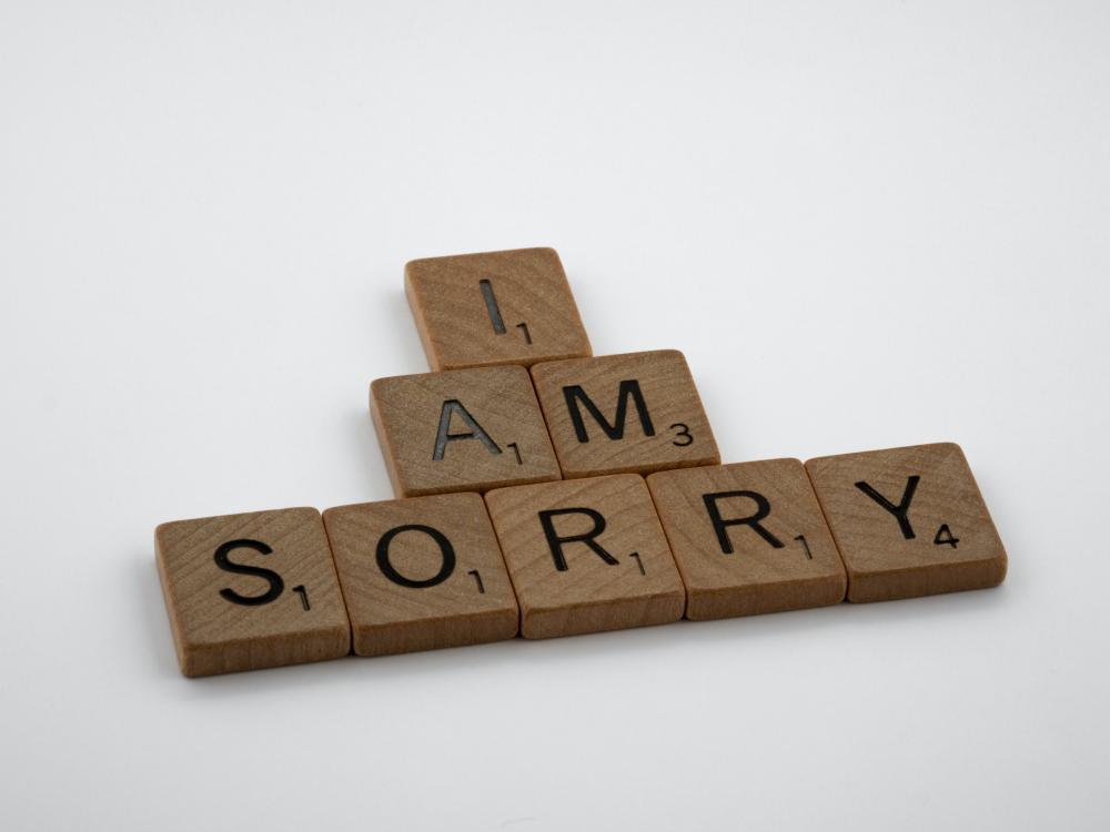 Scrabble tiles spell "I am sorry"