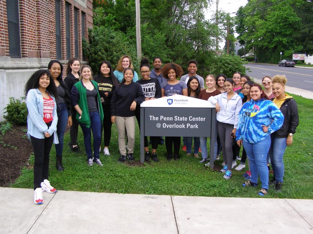 group of high school students by a sign