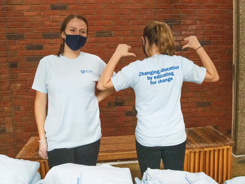 Members of the College of Education Student Council model T-shirts that were handed out during a grab-n-go cookies and cocoa event last fall.