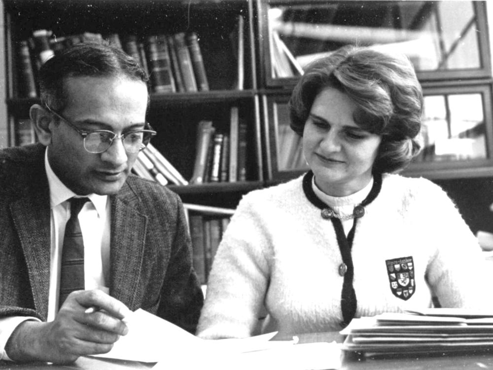 A man and a woman reviewing papers on a desk