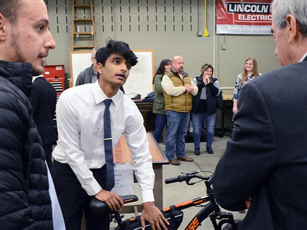 A student in the Electro-Mechanical Engineering Technology program demonstrates his project at the Student Showcase