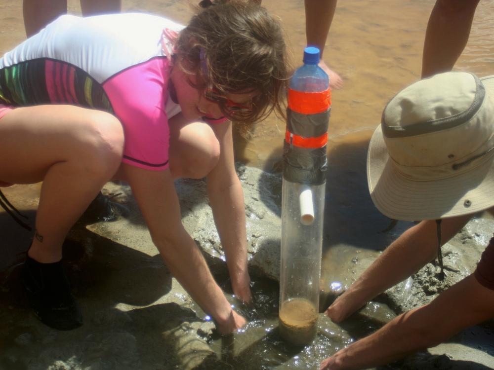 Erin Peeling and Nate Meier help collect a mud core in San Salvador Island for a class-based research trip. The class is focused on understanding the geology, biology and chemistry of the ocean.