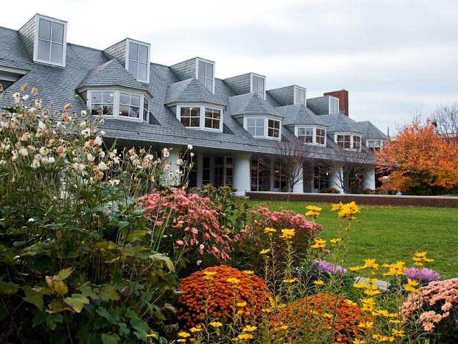 Hintz Family Alumni Center exterior with flowers in the foreground