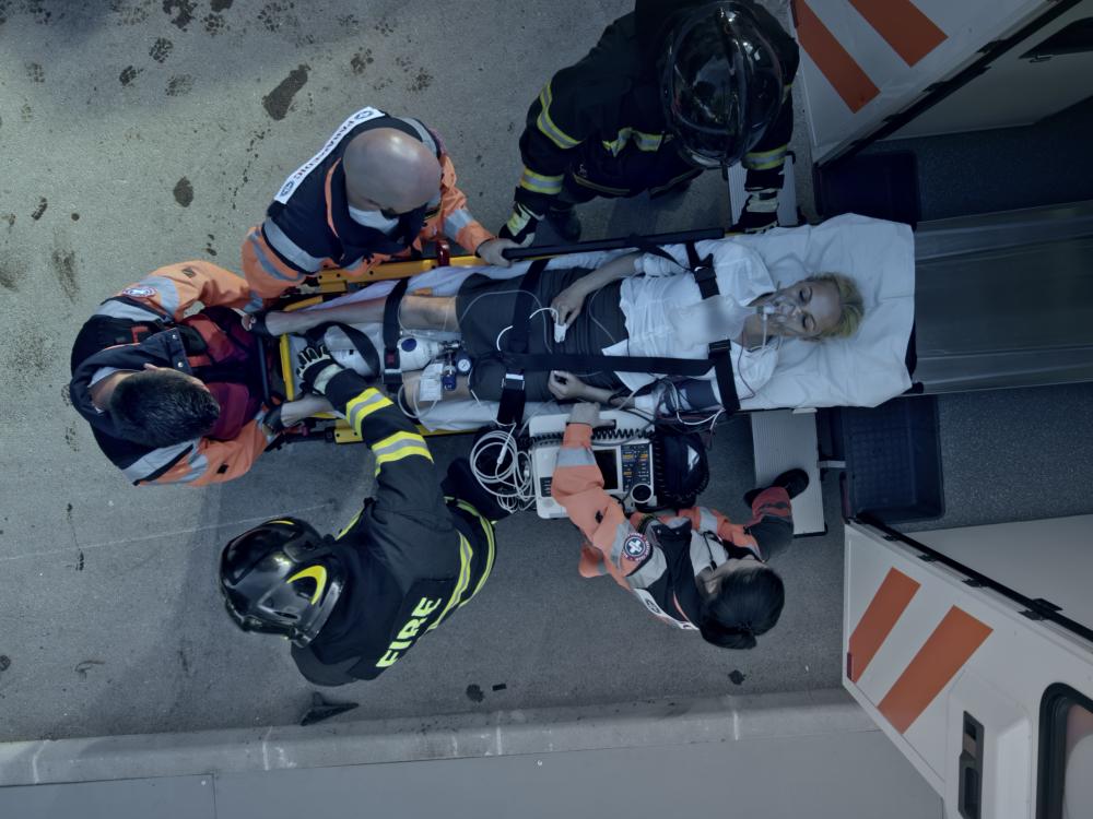 First responders lift and overdose victim into the back of an ambulance