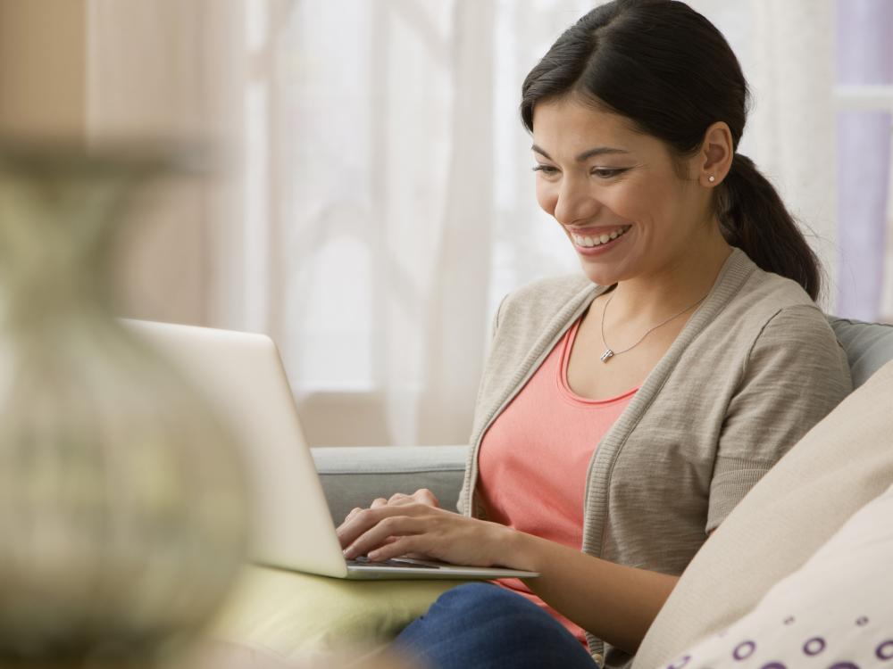 Young woman with laptop on sofa