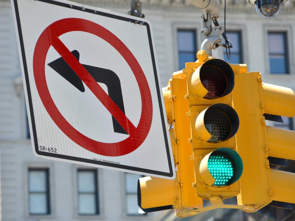 "no left turn" sign at a city intersection