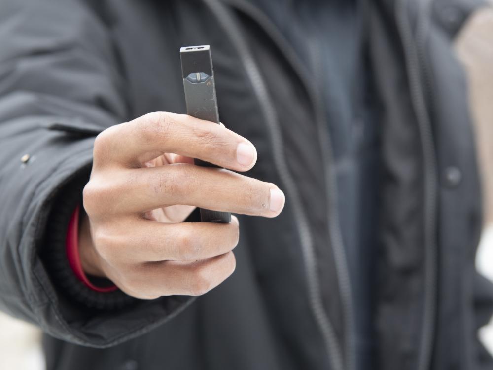 Student holding a Juul pen