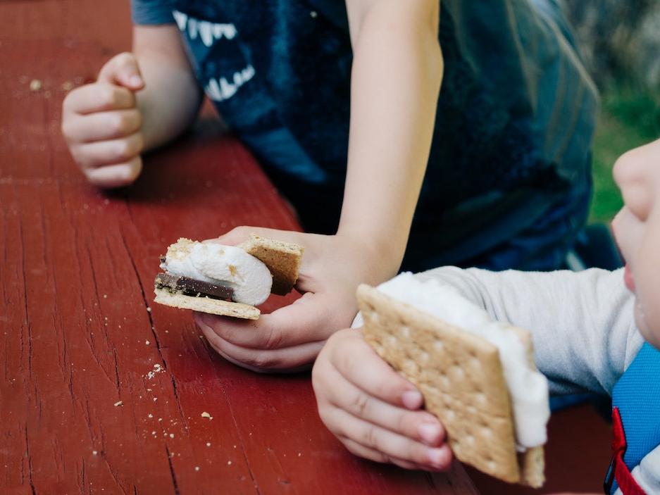 Two young children eating s'mores