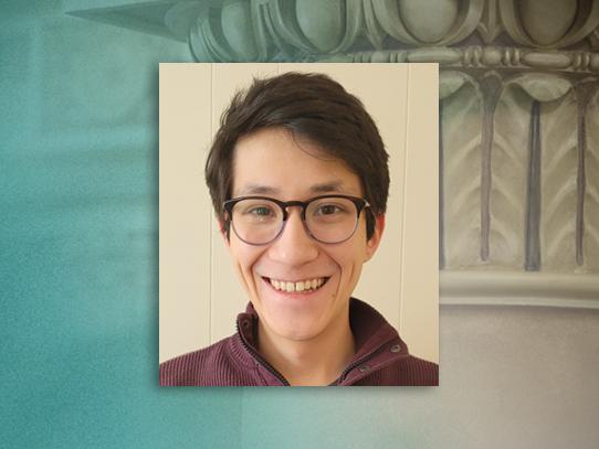 A head and shoulders shot of a young man with glasses over a green and tan background.