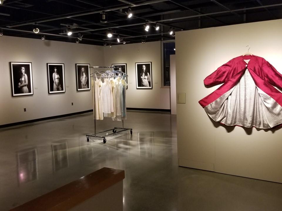Art gallery featuring exhibit of photographs and clothing