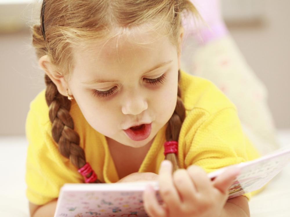 toddler reading book aloud